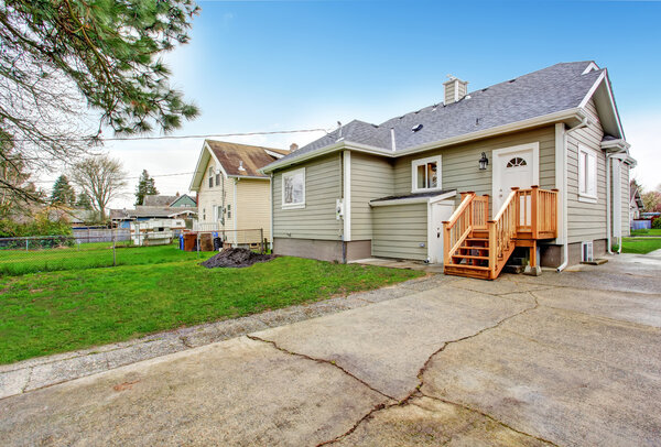 House backyard with small wooden porch