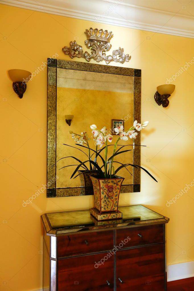 Wooden Cabinet With Decorative Flowerirror Stock Photo Wooden Cabinet With Decorative Flowerirror In Bright Yellow Hallway Photo By Iriana88w