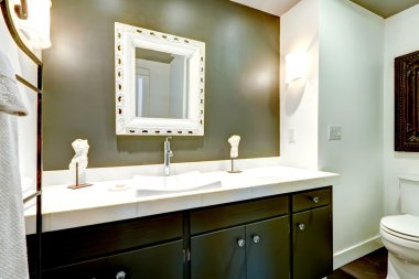 Dark bathroom vanity cabinet with white top clipart