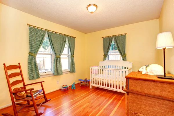 Cozy nursery room with crib and rocking chair — Stock Photo, Image