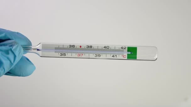 hand checking a medical thermometer with high temperature