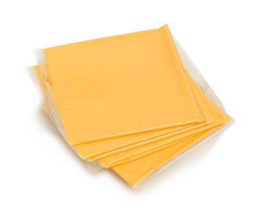 slices of wrapped in nylon cheddar cheese isolated on white