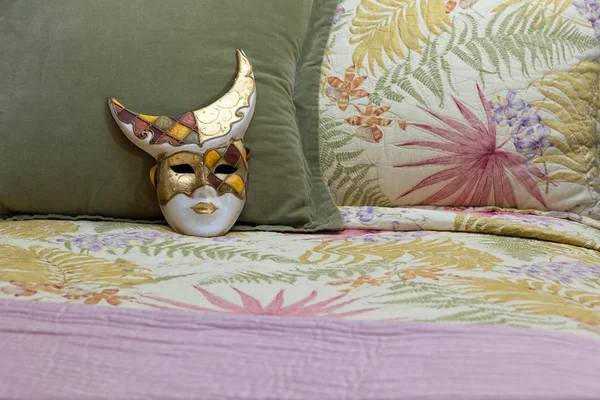 Painted Mask on a Bed