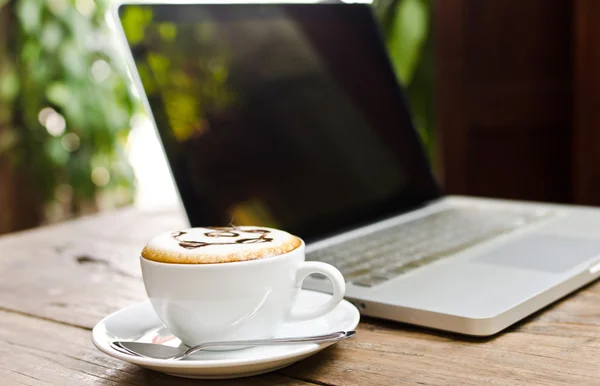 Coffee cup and laptop on the wood texture. — Stock Photo, Image