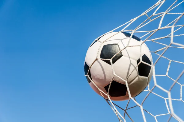 Soccer football in Goal net with the sky field. — Stock Photo, Image