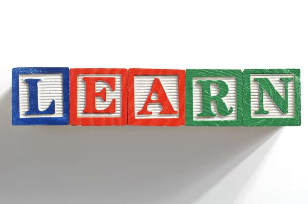 Alphabet Blocks spelling the words learn Stock Picture