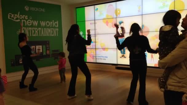Microsoft staff demonstrates with dance game — Stock Video