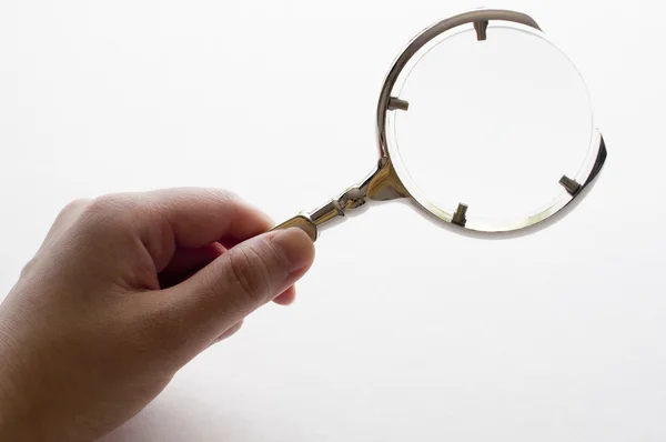 Woman's hand holding magnifying glass — Stock Photo, Image