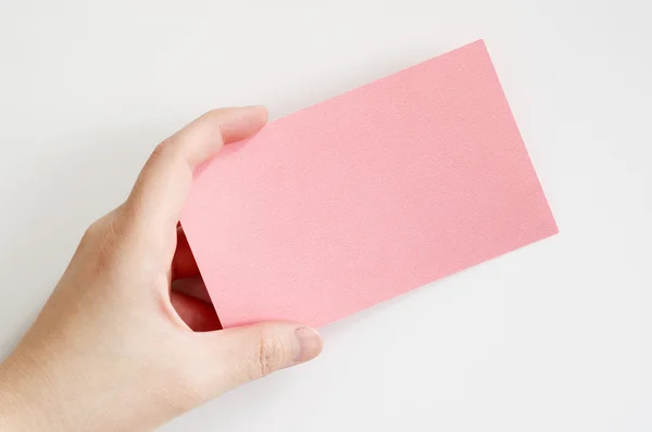 Business woman's hand holding a pink paper — Stock Photo, Image