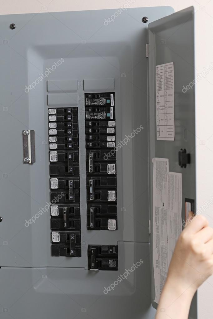 Woman checking automatic fuses at electrical control panel Stock Editorial Photo © payphoto