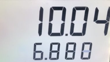 Rising gas prices on station pump screen with 4k resolution