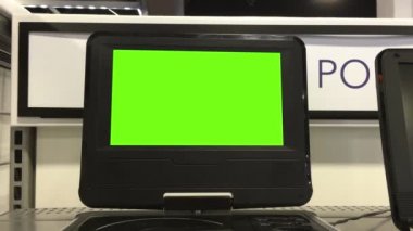 Display DVD player with a green screen inside the electrical store with 4k resolution