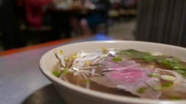 The motion of hot steam beef Vietnamese noodles inside the restaurant with 4k resolution