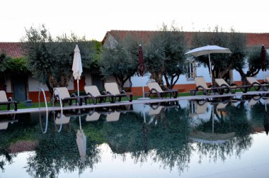 Reflections in the hotel pool at sunset