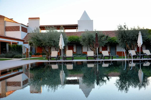 Reflections in the hotel pool at sunset