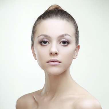 beautiful girl with perfect skin on a light background