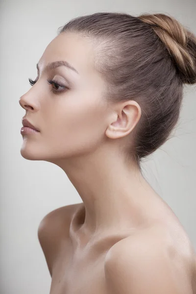 Beautiful girl with perfect skin on a light background Stockafbeelding