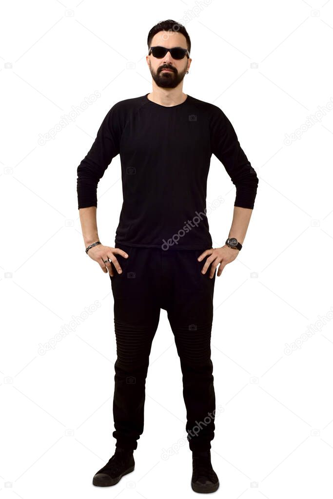 man in sunglasses with a beard in black clothes stands on a white background