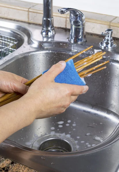 Female hands cleaning chopsticks — Stock Photo, Image