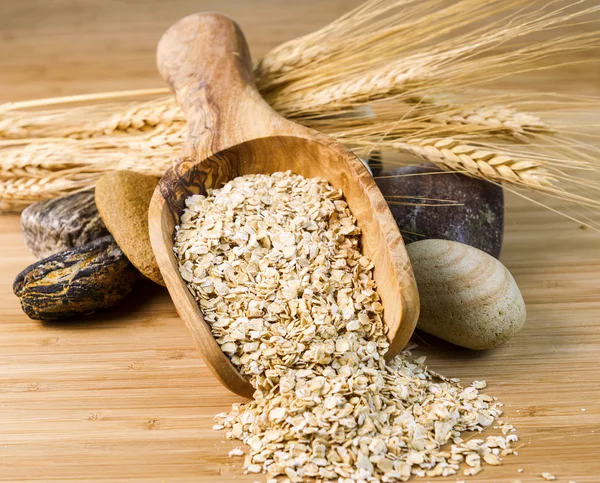 Wooden spoon filled with Raw Rolled Oats — Stock Photo, Image