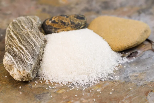 Pile of Fresh Coarse Salt in front of Rocks — Stock Photo, Image