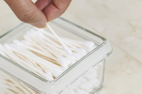 Picking out single cotton swab from container — Stock Photo, Image