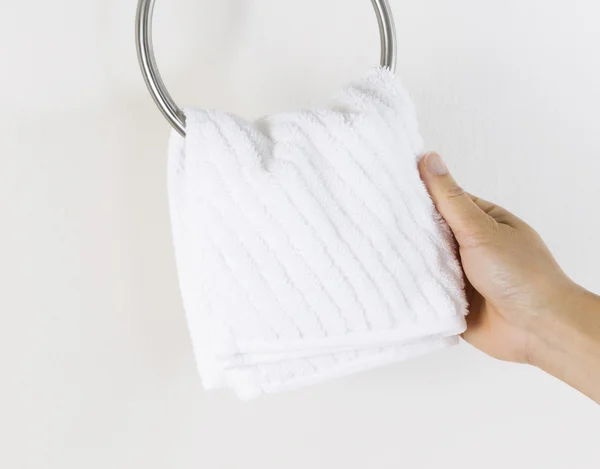 Female hand hanging up small white wash cloth — Stock Photo, Image