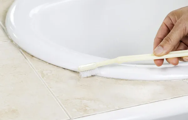 Cleaning Bathroom Sink with Tooth Brush — Stock Photo, Image