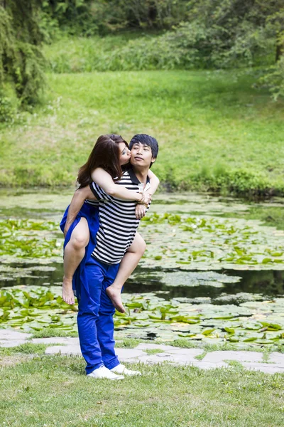 那位女士亲吻她前面的池塘里的情人 — 图库照片