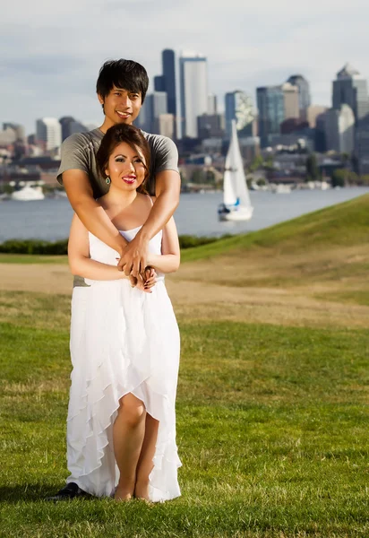 Young Adult Couple Holding each other with City and harbor behin — Stock Photo, Image