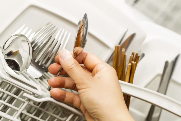 Checking for Cleanliness of Silverware from Dishwasher — Stock Photo, Image