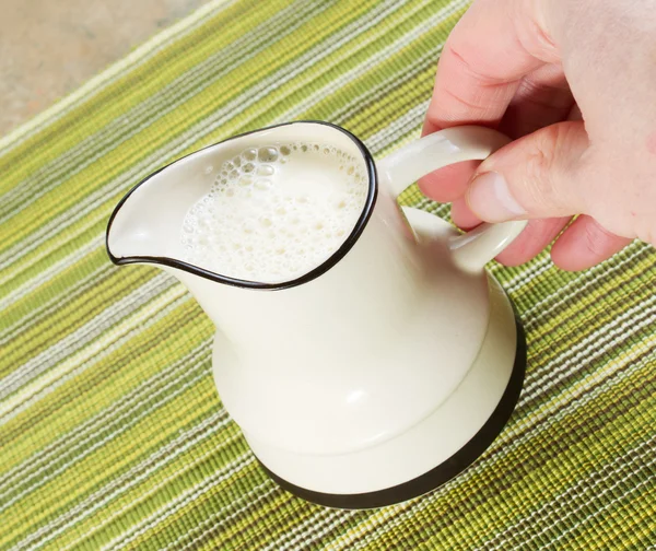 Pitcher of Soy Milk being held by hand — Stock Photo, Image