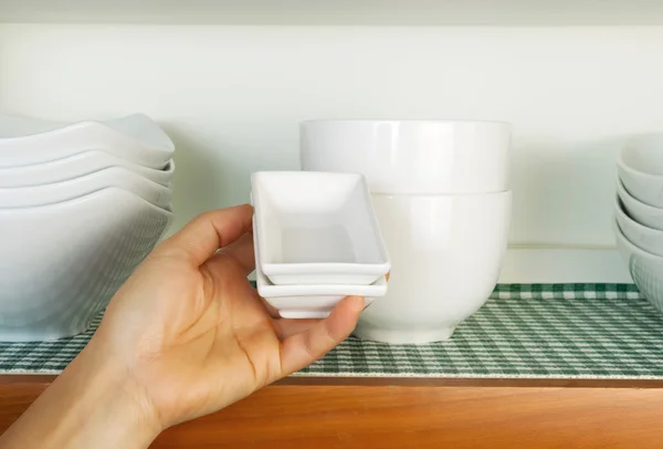Colocando pratos de volta no armário — Fotografia de Stock