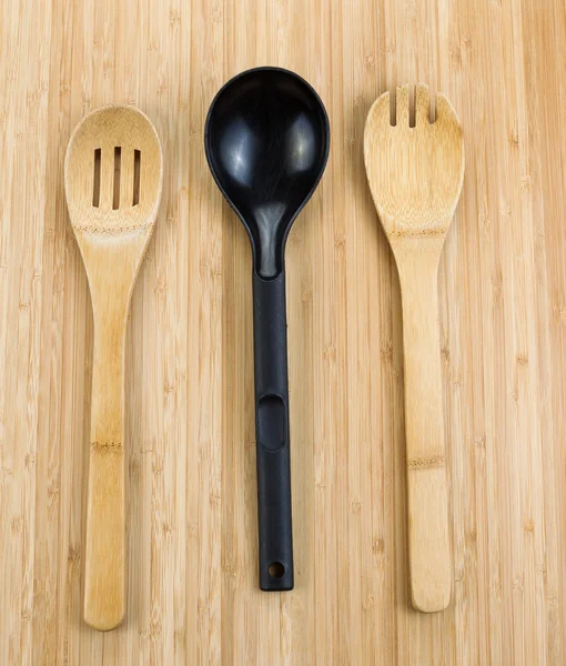 Three kitchen spoons on bamboo wood — Stock Photo, Image