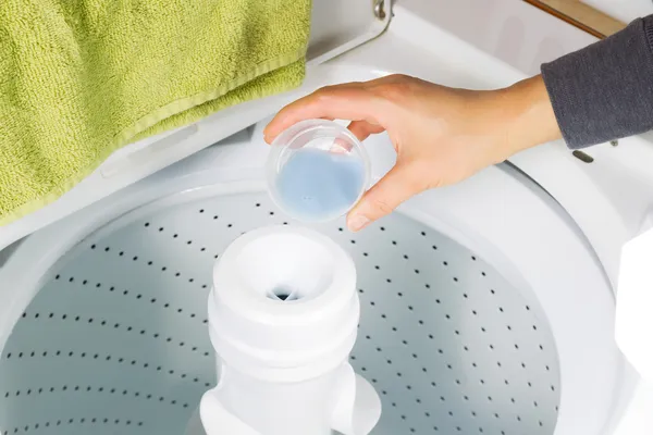 Putting Liquid Soap into washing machine — Stock Photo, Image