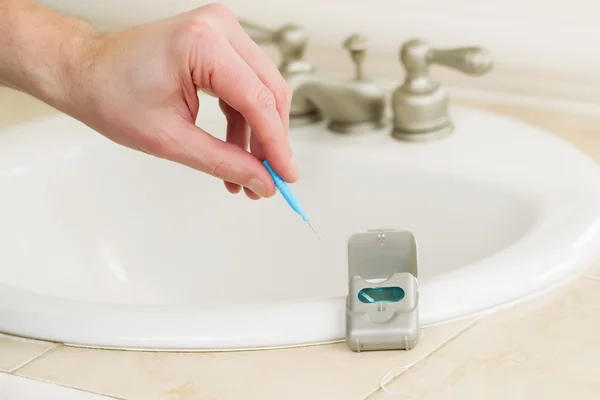 Male hand picking up dental tooth pick to clean his teeth — Stock Photo, Image