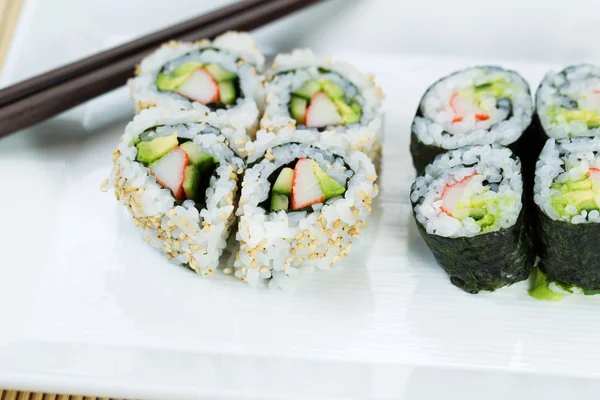 Top view shot of California Rolls in white plate — Stock Photo, Image