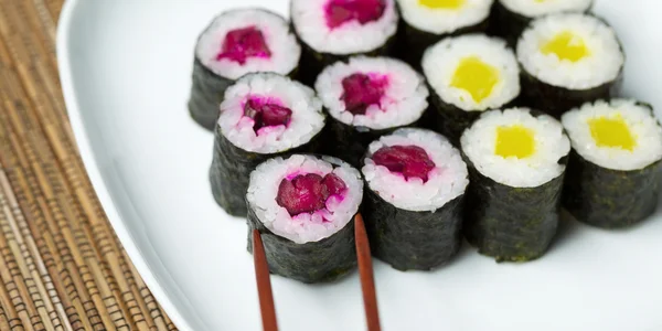 Sélection de Sushi marinés à partir d'une assiette avec des bâtonnets de côtelette — Photo