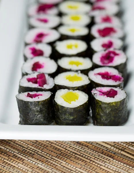 Long Plate filled with Pickled Hand Rolled Sushi — Stock Photo, Image