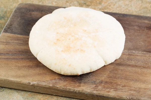 Fresh Pita Bread on Old Serving Board — Stock Photo, Image