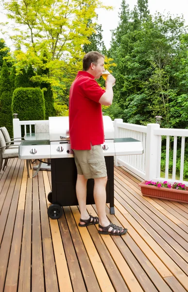 Mature Man relaxing by drinking beer on outdoor patio — Stock Photo, Image