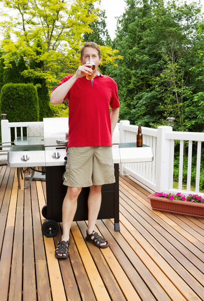 Man drinking beer on outdoor patio 