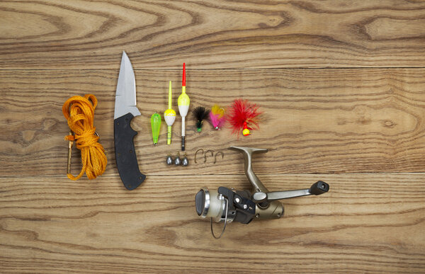 Fishing Kit with assorted equipment on aged wood 