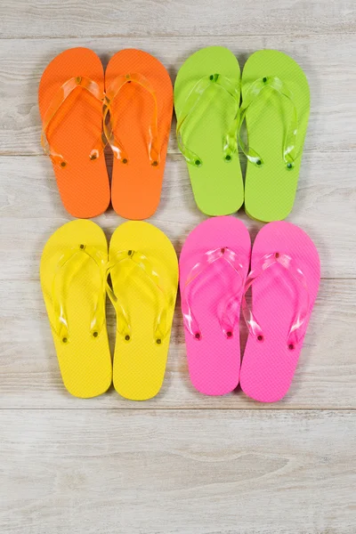 Pairs of New Sandals placed on faded wood — Stock Photo, Image