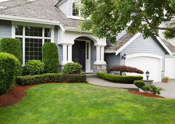 Newly painted and stained exterior of modern home during summert