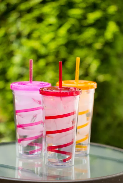 Fresh Clean Water and Ice inside of colorful cups with matching — Stock Photo, Image