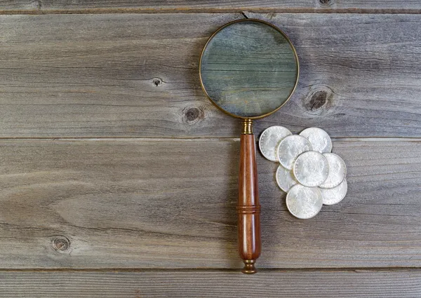 Silver dollar coin collection and round vintage magnify glass on — Stock Photo, Image