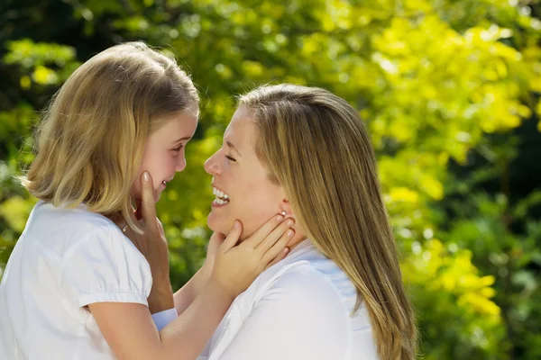 Mother and daughter sharing a moment together outdoors
