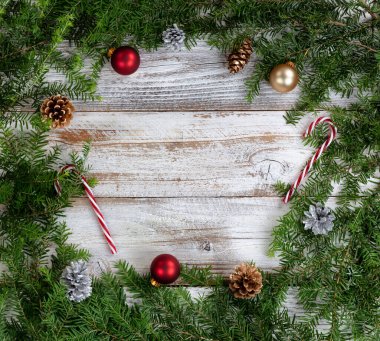 Real fir wreath with traditional decoration ornaments on white rustic wood background for the Christmas or New Year holiday concept  