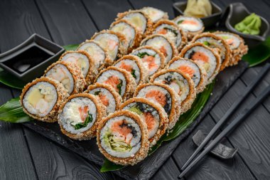 Tempura 'da bir dizi sıcak suşi. Lezzetli tempura ve somon, yılan balığı, salatalık, avokado, omlet ve karides karışımı. Japon Doğu mutfağı.